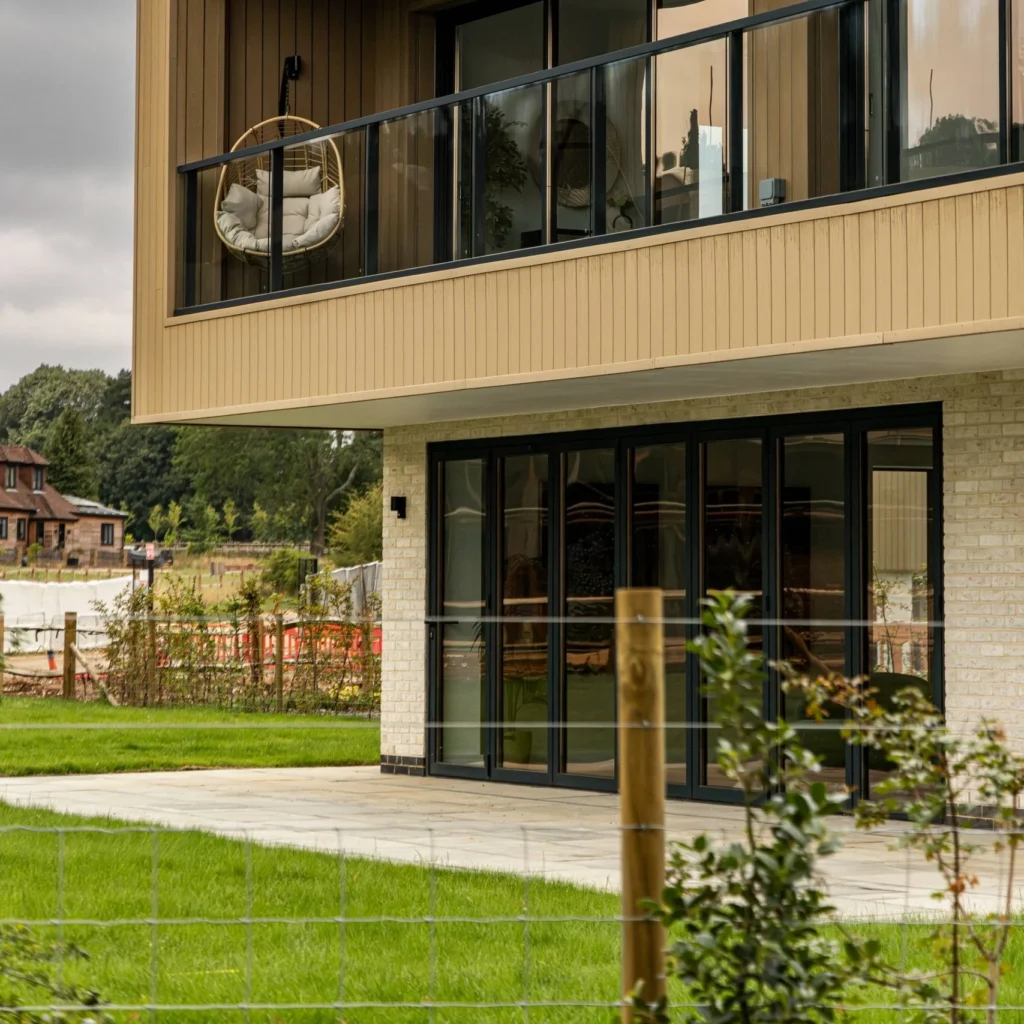 Alulux aluminium bifold doors on a timber-clad new build